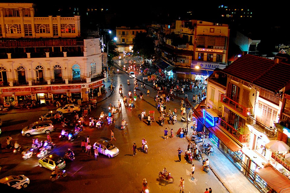 Illustrative Hanoi night scene; this is not a vehicle operated by our team.